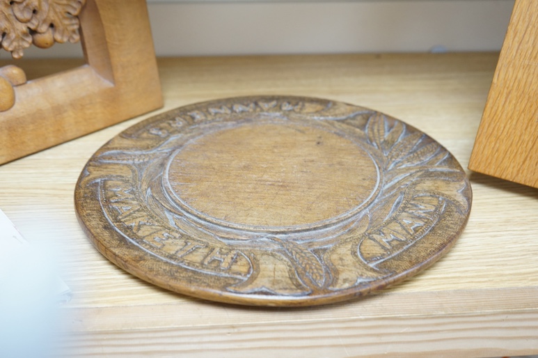 A pair of Roger Sutton carved oak panels depicting pear and oak trees and a bread board ‘Maketh Man Manners, largest 44cm wide. Condition - good (3)